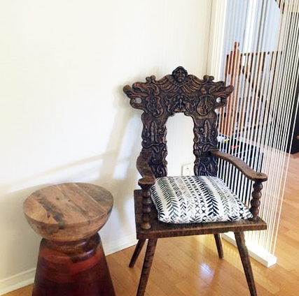 vintage carved chair, and a black and white cushion, paired with a wooden table